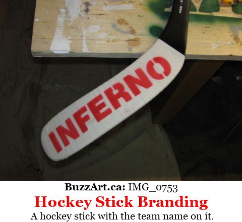 A hockey stick with the team name on it.